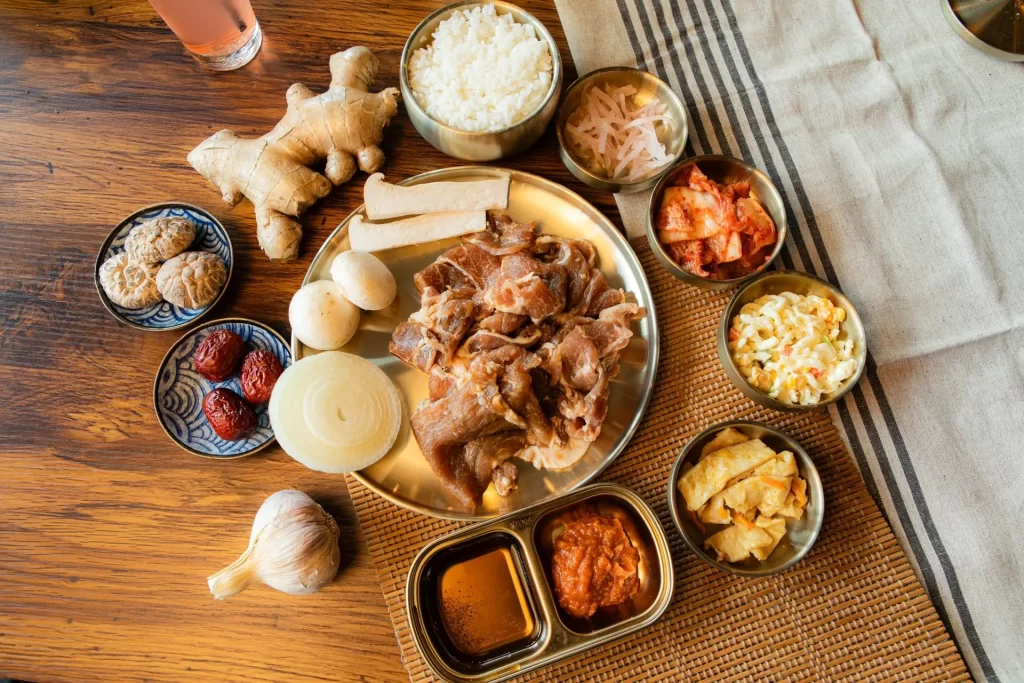 Korean BBQ pork platter with garlic, mushrooms, rice, and side dishes at Geonbae Frankston VIC